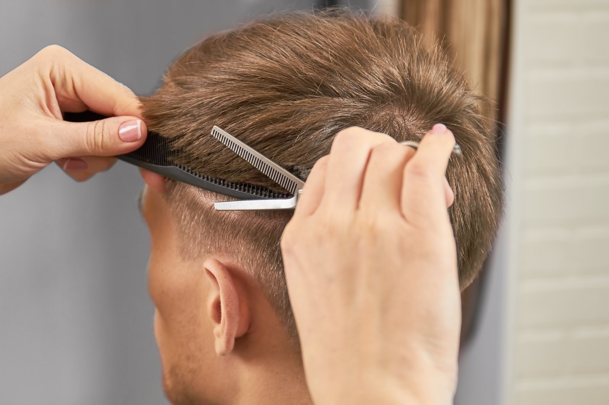 Hands of barber cut hair